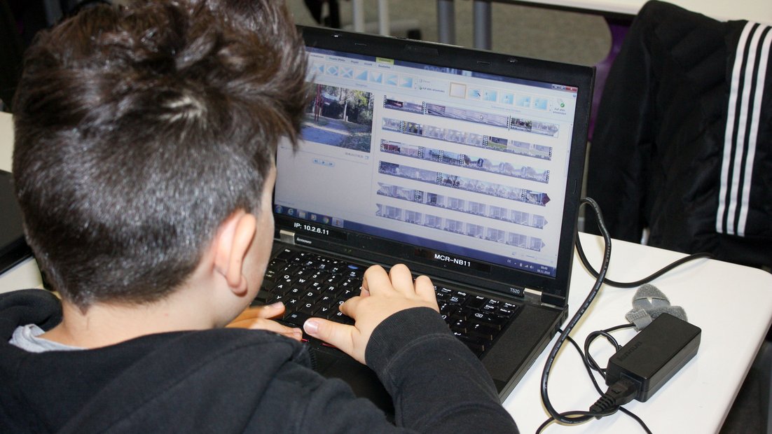 Schüler beim Videoschnitt am Laptop